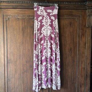 Plum purple and white skirt 96% rayon 4% spandex. Unknown brand size small.